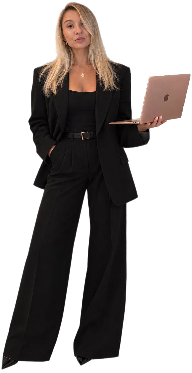 A woman in a black suit holding a laptop